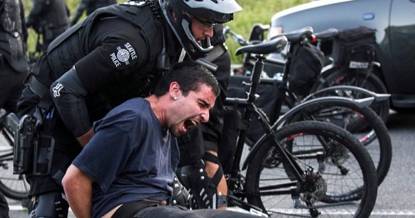 Police detain a protester during anti-capitalist protests following May Day marches in Seattle, Washington, U.S. May 1, 2016.