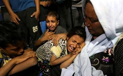 Relatives of Palestinian woman Zeina Al Omor, who was killed by fragments of an Israeli tank shell, mourn during her funeral in the southern Gaza Strip May 5, 2016.