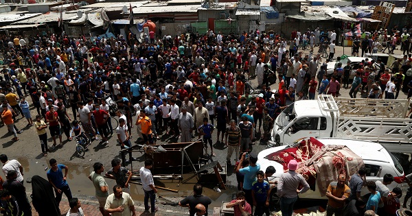 People gather at the scene of a car bomb attack in Baghdad's Sadr City, May 11, 2016.