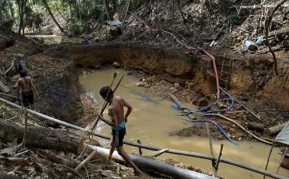 Yanomami indians follow agents of Brazil's environmental agency in an illegal gold mine in the heart of the Amazon rainforest, in Roraima state, Brazil.