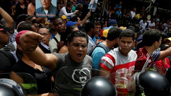 Opposition supporters clash with riot policemen during a rally to demand a referendum to remove President Nicolas Maduro in Caracas, Venezuela, May 18, 2016.