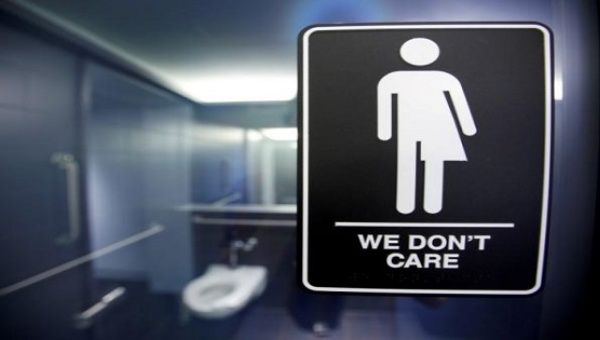 A sign protesting a recent North Carolina law restricting transgender bathroom access is seen in the bathroom stalls at the 21C Museum Hotel in Durham, North Carolina, May 3, 2016.