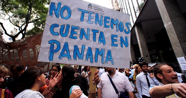 A state worker holds up a sign that reads 