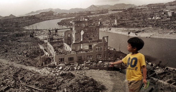 A child observes a photo of the destruction left behind by the U.S. nuclear bombing of Hiroshima.