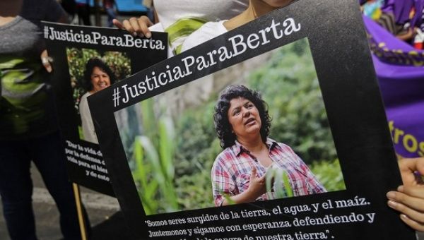 Demonstrators carry signs demanding justice for murdered Honduran environmental leader Berta Caceres.