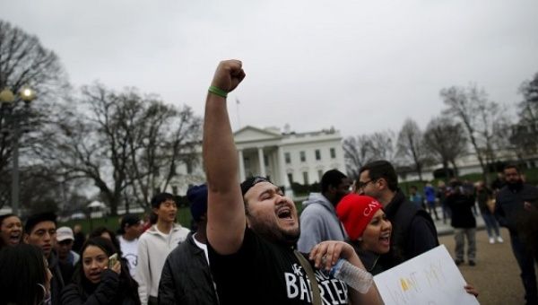 Anti-deportation demonstrators protest outside of the White House in Washington.