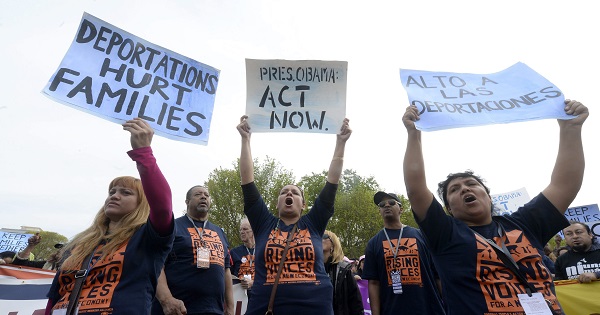 Protesters demand President Obama to stop immigration raids.