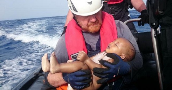 A German rescuer from the humanitarian organisation Sea-Watch holds a drowned migrant baby, off the Libyan cost May 27, 2016