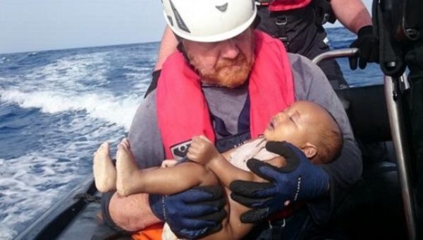 A German rescuer from the humanitarian organisation Sea-Watch holds a drowned migrant baby, off the Libyan cost May 27, 2016