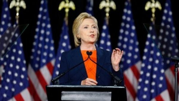 Clinton wears orange for gun violence awareness but holds a violent record on U.S. foreign policy.