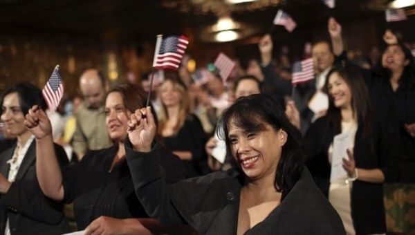 Immigrants wave flags following a US Citizenship and Immigration Services ceremony in California.