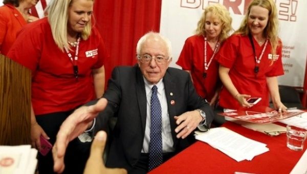 Vermont Senator Bernie Sanders shakes hands with a supporter during a 'Brunch With Bernie' rally at National Nurses United in Oakland, California August 10, 2015.