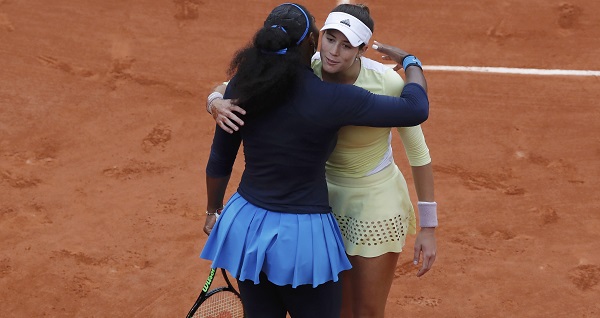 Muguruza hugs Williams at the end of their match.