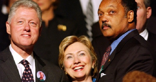 Former U.S. President Bill Clinton and his wife Hillary Clinton and civil rights leader the Reverend Jesse Jackson in Minneapolis, Oct. 29, 2002.