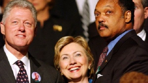 Former U.S. President Bill Clinton and his wife Hillary Clinton and civil rights leader the Reverend Jesse Jackson in Minneapolis, Oct. 29, 2002.