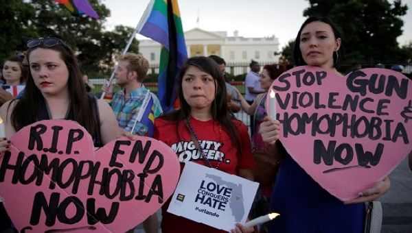 People hold a vigil after the worst mass shooting in U.S. history at a gay nightclub in Orlando, Florida, in front of the White House in Washington, U.S., June 12, 2016. 