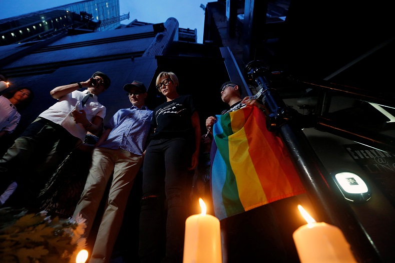 Hong Kong residents  take part in a candlelight vigil to mourn victims of the shooting at a gay nightclub in Orlando, in Hong Kong, China June 13, 2016.