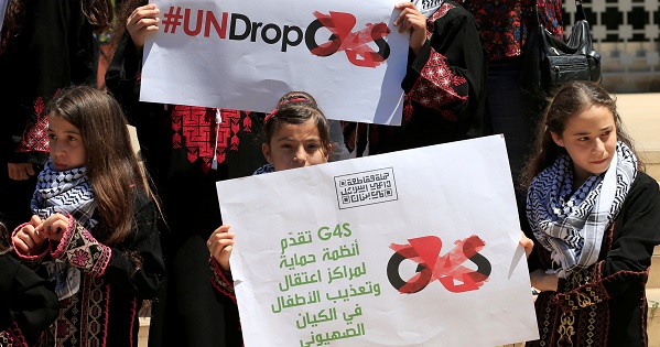People carry placards while attending a demonstration in support of Palestine near the Central bank in Beirut, Lebanon.