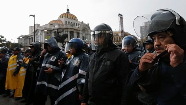 Riot police stand guard outside the Bellas Artes theatre as people from the CNTE teachers’ union take part in a march against President Enrique Pena Nieto's education reform, Mexico City, Mexico June 30, 2016.