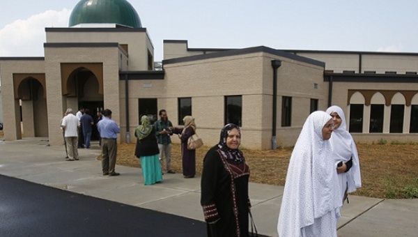 People leave a mosque as hate crimes against Muslims in the U.S. escalate.