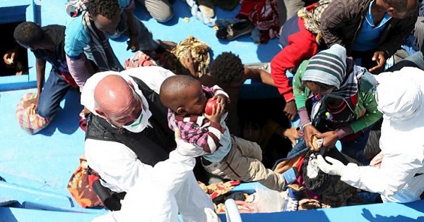 Children, part of a group of 300 sub-Saharan Africans, are helped to board by the Italian Finance Police during a rescue operation off the coast of Sicily.