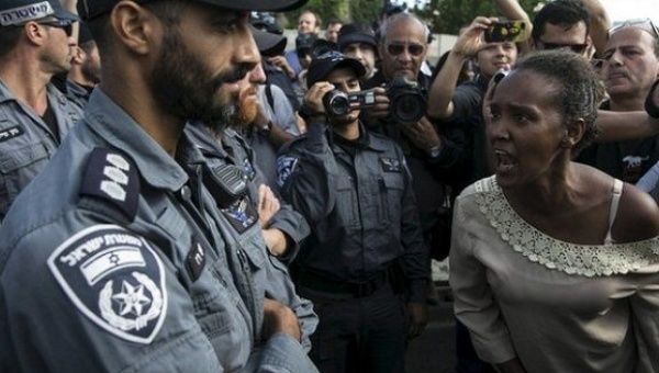 A protester, who is an Israeli Jews of Ethiopian origin, shouts at a policeman during a demonstration last year against police racism and brutality.