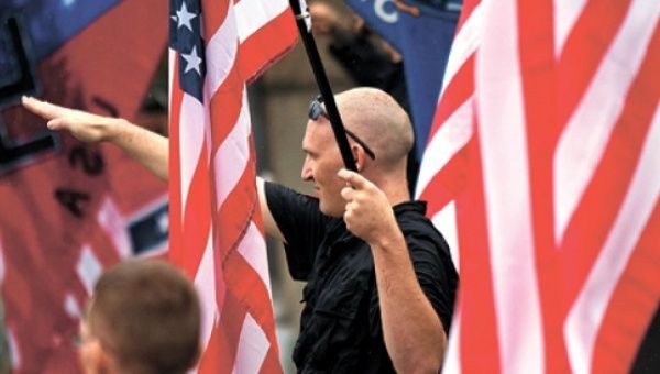 An American neo-Nazi giving the Fascist salute during a rally in Wisconsin in 2011.