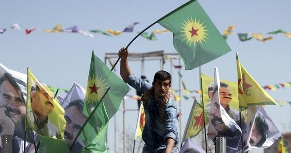 A demonstrator waves a flag of the Kurdistan Workers Party (PKK) in the city of Diyarbakir, Turkey. March 21, 2016