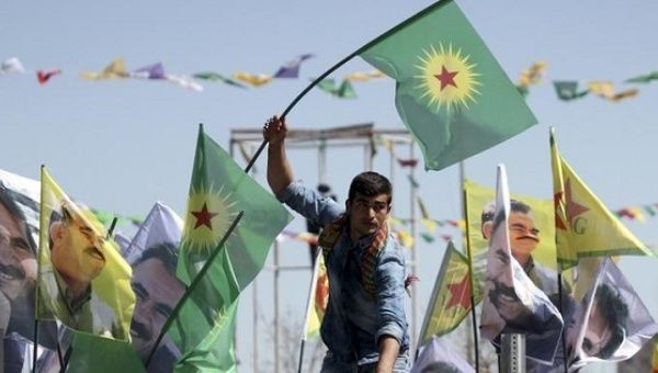 A demonstrator waves a flag of the Kurdistan Workers Party (PKK) in the city of Diyarbakir, Turkey. March 21, 2016