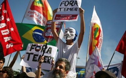 A protester holds a sign that reads 