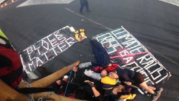 Black Lives Matter UK lock themselves together on a London City Airport runway.