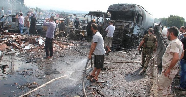 Syrian army soldiers and civilians inspect the site of two explosions in Tartous.