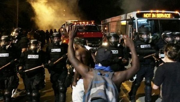 Police officers block a road during protests after police fatally shot Keith Lamont Scott in the parking lot of an apartment complex, Sept. 20, 2016. 