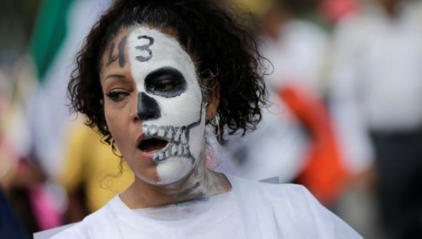 A woman takes part in a march in Mexico City, with a 43 on her face referring to the missing students of Ayotzinapa.