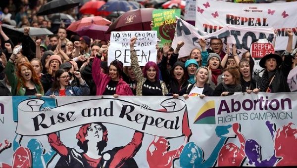 Demonstrators take part in a protest to urge the Irish Government to repeal strict limitations on a woman's right to an abortion, in Dublin, Sept. 24, 2016. 