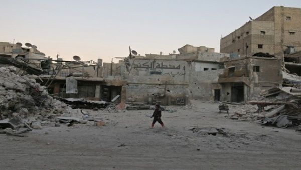 A boy walks amid damaged buildings in the rebel held area of al-Kalaseh neighbourhood of Aleppo, Syria, Sept. 29, 2016.