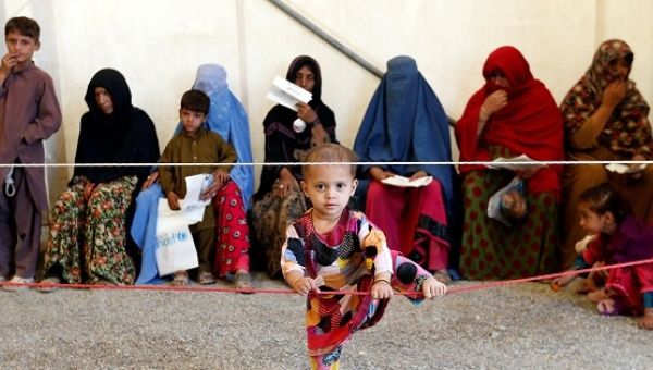 Afghan women sit with their children after arriving at a United Nations High Commissioner for Refugees registration center in Kabul, Afghanistan September 27, 2016.