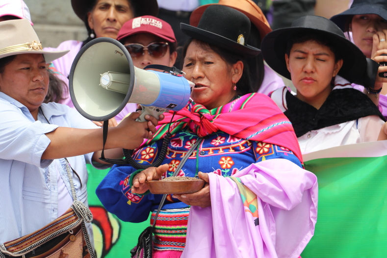 Indigenous women prepare offerings to Mother Earth and call to protect her before the start of the march. 