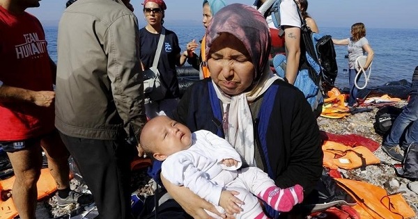 An Afghan refugee holds her three-month-old baby girl Zainab after arriving at a beach on the Greek island of Lesbos after crossing a part of the Aegean sea from Turkey Sept. 17, 2015.