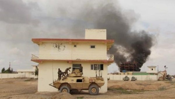 Smoke billows from a building after a Taliban attack in Gereshk district of Helmand province, Afghanistan, March 9, 2016.