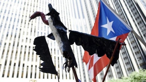 A vulture puppet is held at a protest against Puerto Rico's credit holders as a symbol of the so-called vulture funds. 