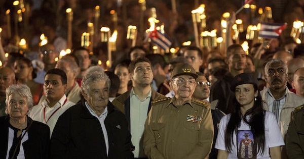 Cuba's president, Raul Castro (front 2ndR) and former Uruguayan President Jose Mujica (2ndL) lead the march of the torches in celebration of the 163rd birth anniversary of Cuba's independence hero Jose Marti in Havana.