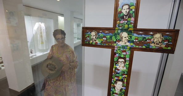 A cross bears the photos of the six Jesuit priests who were murdered by the U.S.-trained Salvadorean army in 1989 during the brutal civil war.