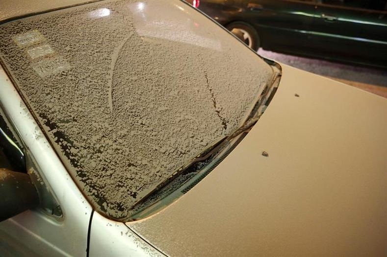 A car covered in ash following multiple eruptions of Turrialba volcano.