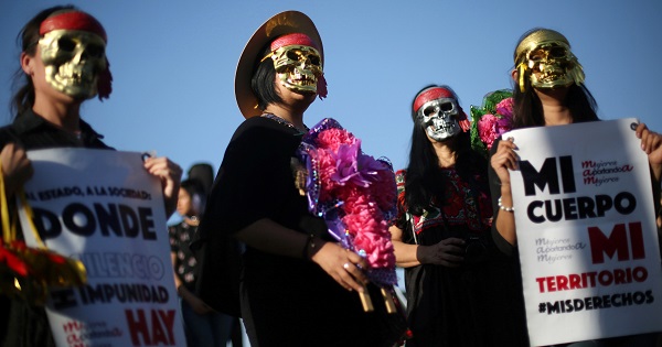 Activists in Mexico City take part in a march to protest violence against women and the murder of a 16-year-old girl in Argentina, Oct.19, 2016.