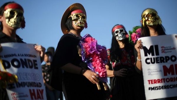 Activists in Mexico City take part in a march to protest violence against women and the murder of a 16-year-old girl in Argentina, Oct.19, 2016. 