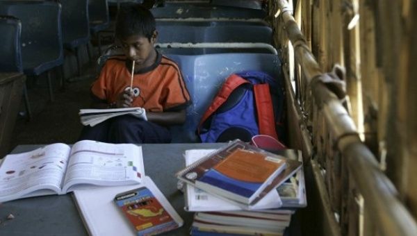 A student receives lessons inside an old bus turned into a class room in the settlement of Pueblo Nuevo, Oaxaca.