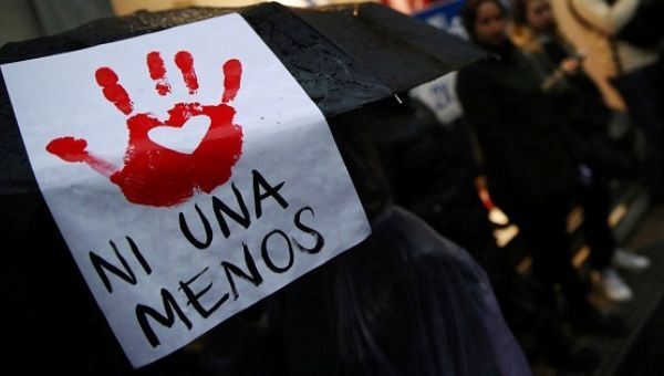 A woman carries a sign during a demonstration to demand policies to prevent gender violence in Buenos Aires, Argentina, Oct. 19, 2016.