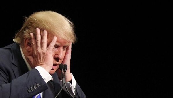 U.S. President-elect Donald Trump reacts during a speech.