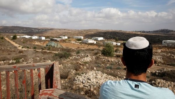 An Israeli youth stands on an observation point overlooking the Jewish settler outpost of Amona in the West Bank Nov. 16, 2016. 